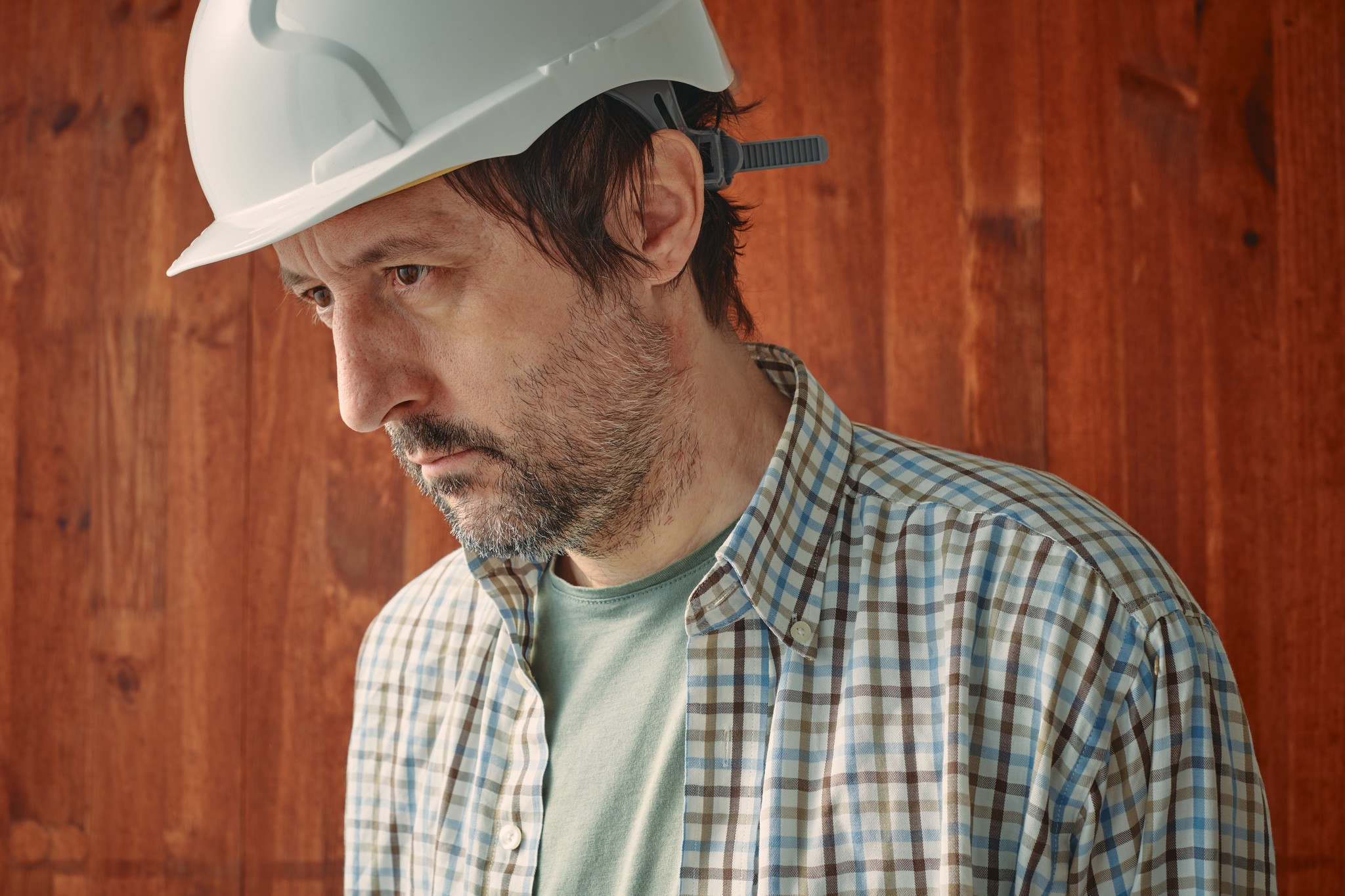 Portrait Of Concerned Male Worker With White Protective Helmet,